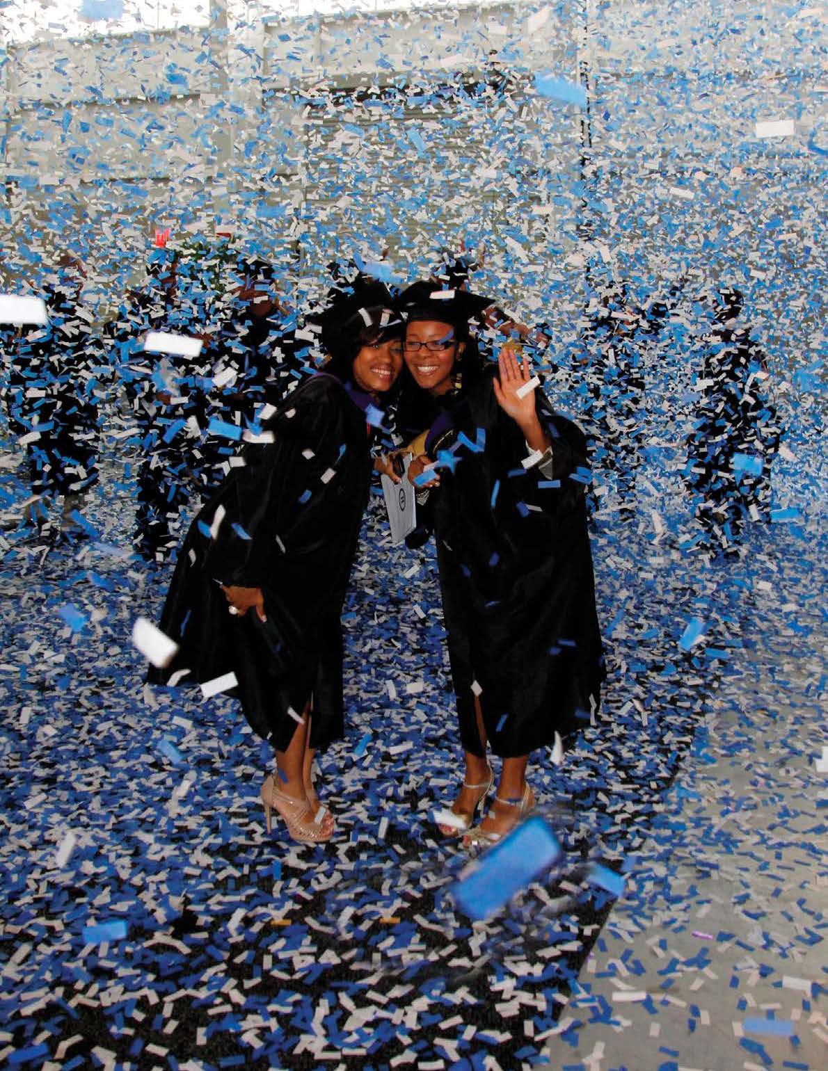 Two female John Jay graduates celebrating with confetti, representing student success