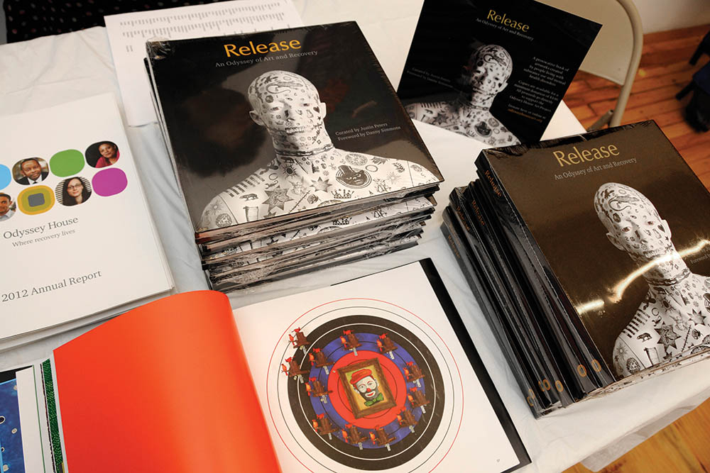 Display setup showing Odyssey House art program coffee table book presented as donor gift