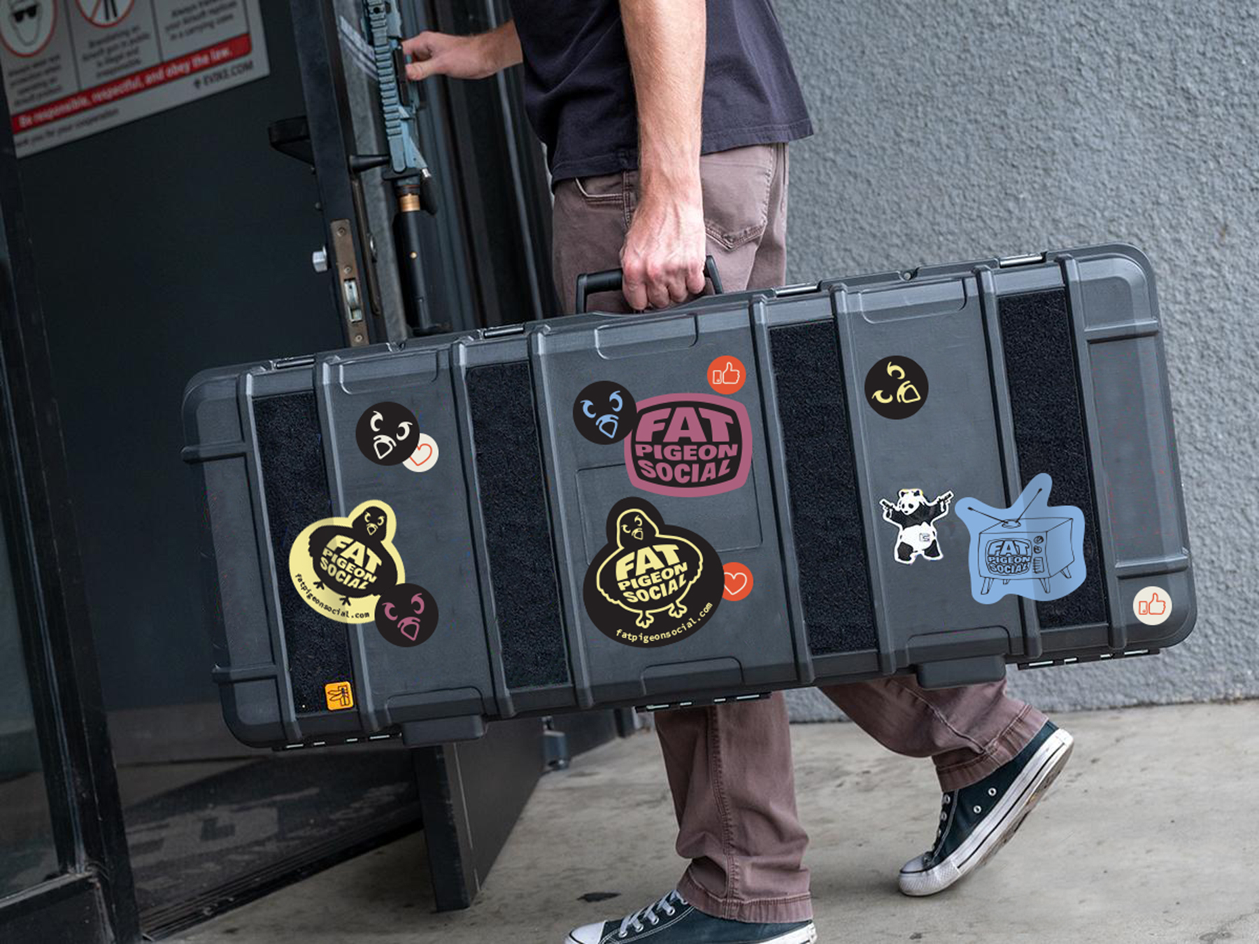 Fat Pigeon Social logo stickers applied to photography equipment case showing brand integration with professional tools